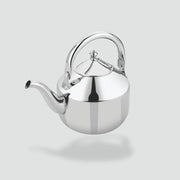 Shiny stainless steel tea kettle with curved spout and top handle on gray background